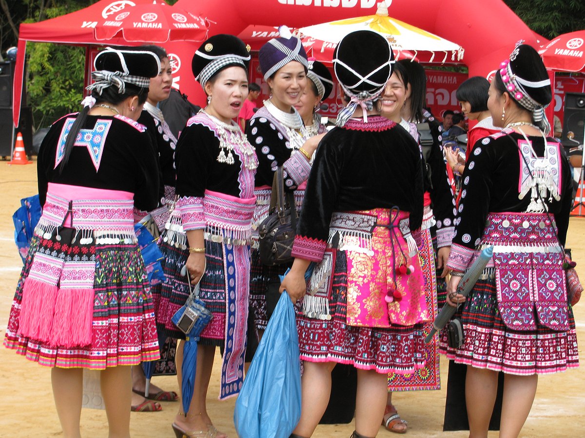 H'mong women wearing batiked and embroidered traditonal pleated skirts at New Year, Thailand